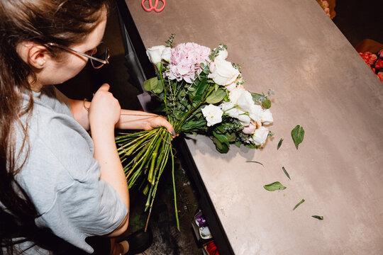 Florist preparing a large flower bouquet