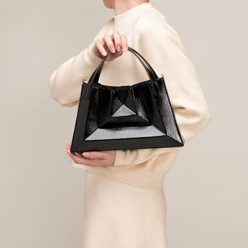 Stylish Black Handbag Held by Model