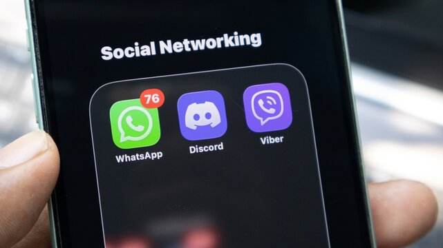 Social networking folder on smartphone screen featuring whatsapp discord and viber icons.