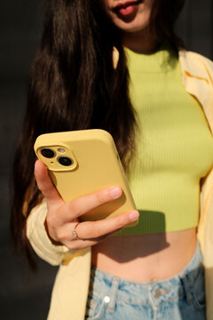 Close up crop of anonymous woman typing a message on mobile phone