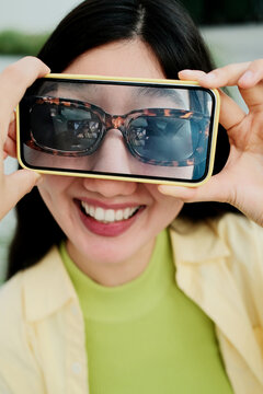 Close up creative photo of happy young woman with mobile phone