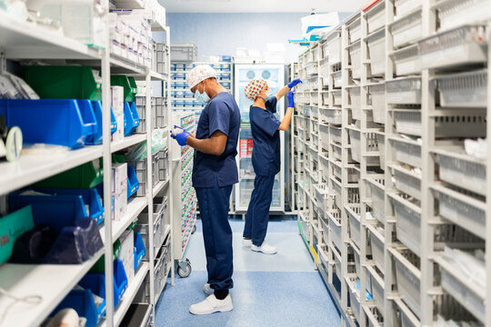 Healthcare professionals managing medical supplies in storage room