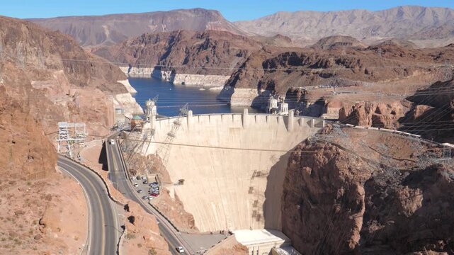 Panoramic view revealing hoover dam, concrete arch gravity dam in black canyon of colorado river, with lake mead reservoir showing low water levels due to drought conditions
