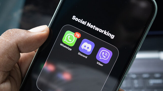 Smartphone displaying messaging app icons with red notification badge for social networking and digital communication on dark mobile screen.