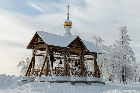 Snow-Covered Bell Pavilion and Frosted Trees in Winter Sun