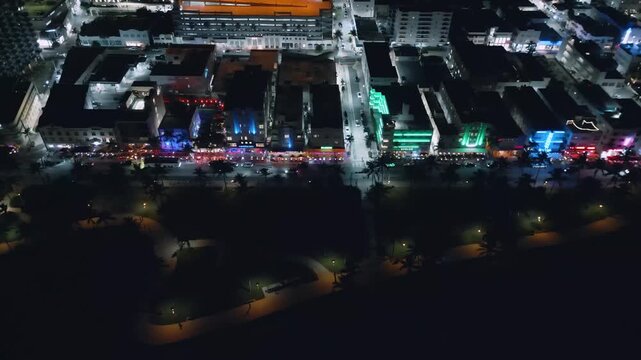 Luminous Collins Avenue flows through Miami Beach in continuous aerial night movement