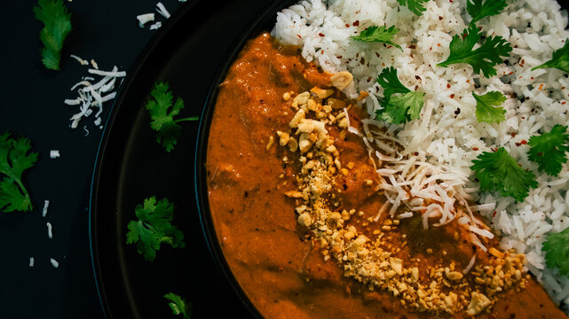 Delicious Meal With Rice and Curry Served on a Black Plate