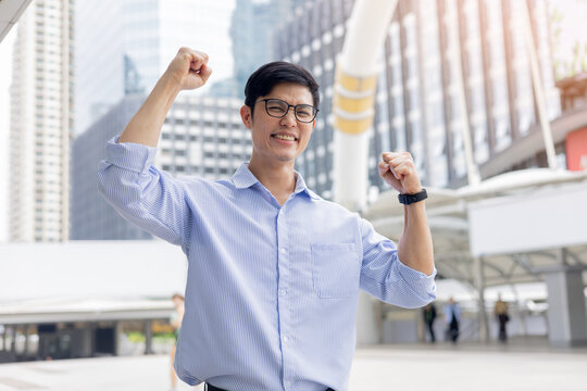 close up young asian businessman excited and happiness feeling after complete and get a new job position in city for new career path concept