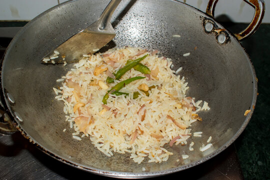preparing new rice dish using leftover boiled rice, demonstrating a practical way to reuse leftover food and reduce household food waste.