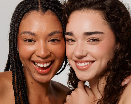 Two Friends Smiling at the Camera During a Photo Session