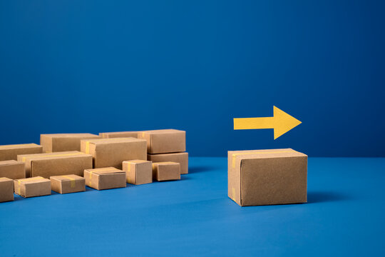 Creative arrangement of cardboard boxes with an arrow on a box