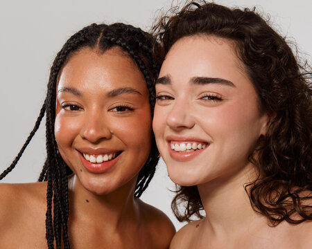 Two Women Smiling and Posing Together for a Close-Up Picture