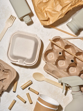 Eco-friendly disposable items and containers on a textured surface