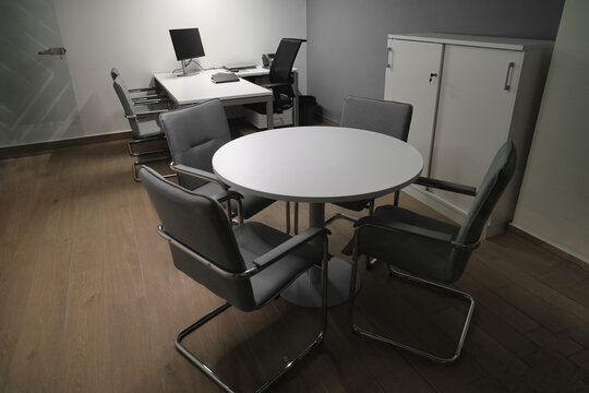 Spacious office interior with personal computers laptop telephone on 2 two tables  modern new small office interior.