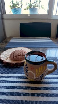 Traditional mexican concha sweet bread and steaming coffee for a classic breakfast