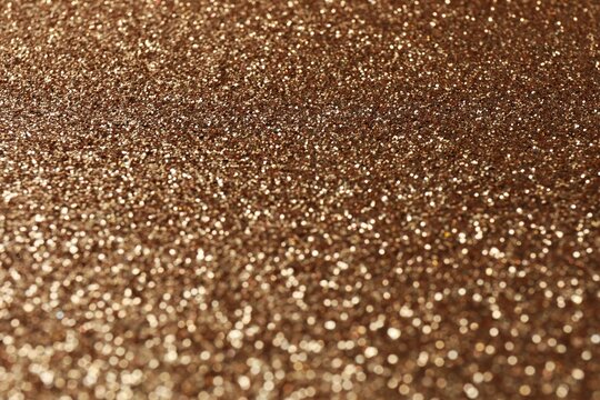 Shiny bronze background. Shimmering copper. Abstract shimmering texture. Surface sheen. Shimmering mockup.  Luxurious, festive background