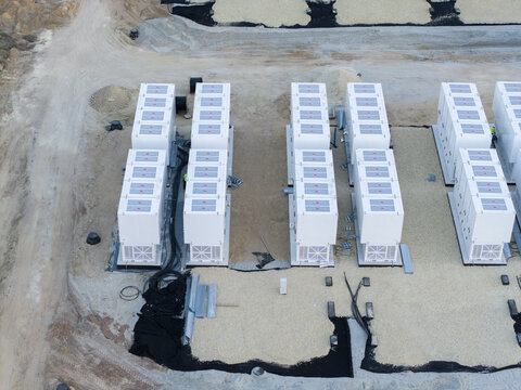 Aerial view of the BESS energy storage facility under construction with rows of white battery containers on a gravel site in Trzebinia, Lesser Poland Voivode, Poland.