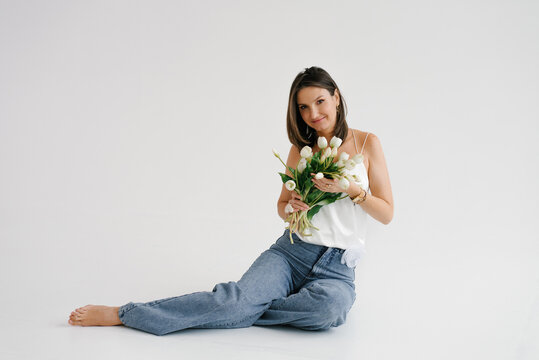 Woman Sitting on Floor With Tulip Bouquet