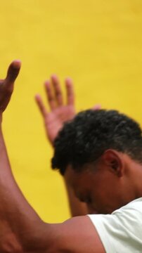 African American man raising hands in joyful outdoor praise and spiritual devotion, tracking shot