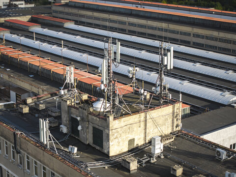 Aerial view of telecommunication antennas and relays installed on the rooftop of an industrial building in Krakow, Lesser Poland Voivode, Poland.