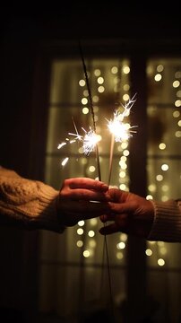 Hands Holding Sparklers near Window Concept of New Year Eve video, Festive Celebration, Christmas Cozy Winter Night, Holiday Moments