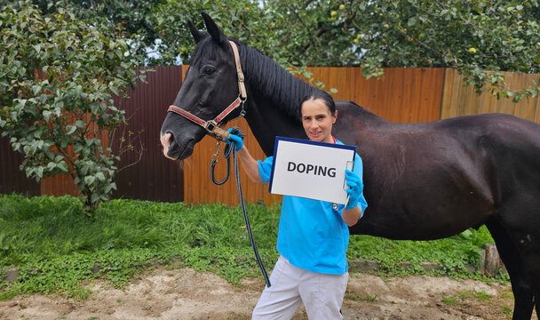 Vet checks horse for doping in a stable with trees