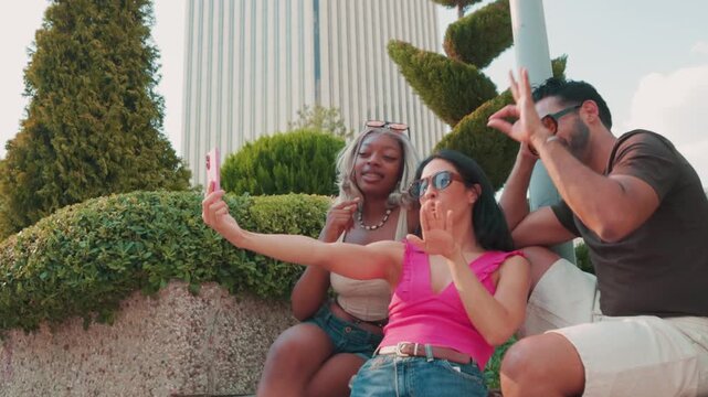 Diverse friends taking funny selfies outdoors