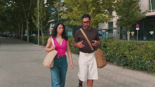 Young professional colleagues walking and talking after work