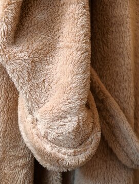 A close-up view of a towel hanging on a hook, ready to be used