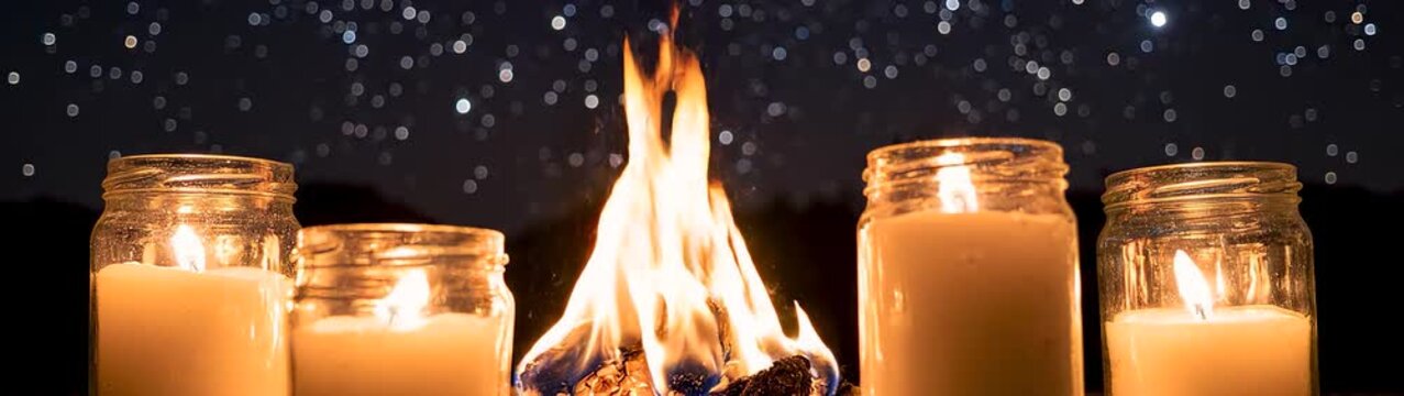 Mindfulness and spiritual meditation concept row of burning candles in glass jars under a starry night sky slow motion flickering flames for wellness and relaxation.