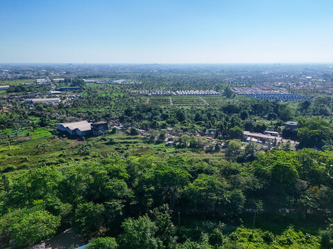 Aerial view of the lush green landscape and urban outskirts of Banjarmasin City, South Kalimantan, Indonesia.
