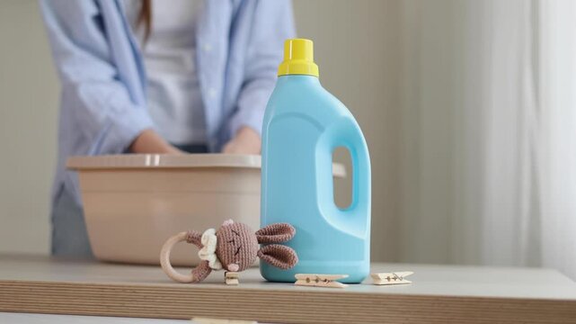 Hand washing children's clothes in soapy water with laundry detergent, gentle household care and hygiene