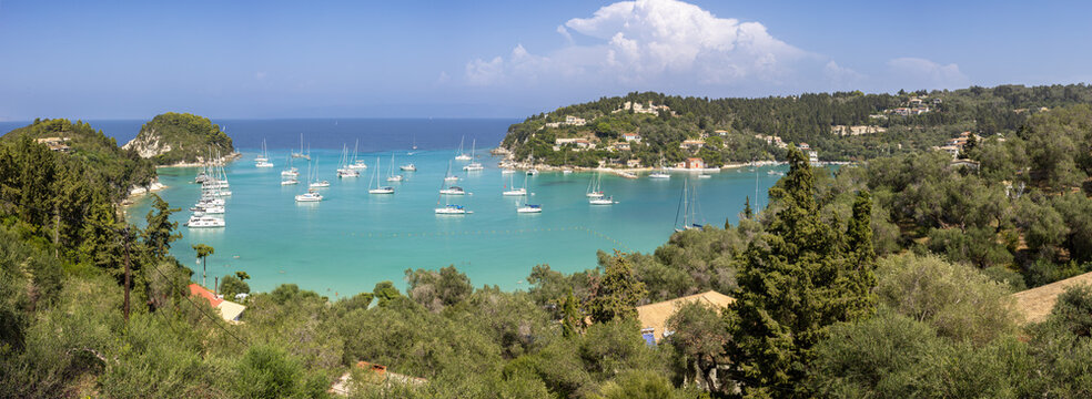 The bay of Lakka with turquoise colored water. Boats anchoring. Island of Paxos, Greece.