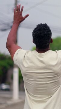 African American man raising arms to sky in joyful spiritual gratitude and faithful devotion