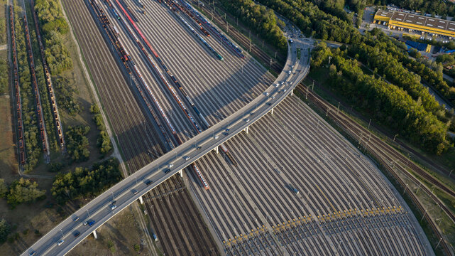 Aerial view of Dachauer Brucke crossing over an extensive railway yard with multiple tracks and freight trains in Munich, Bavaria, Germany.