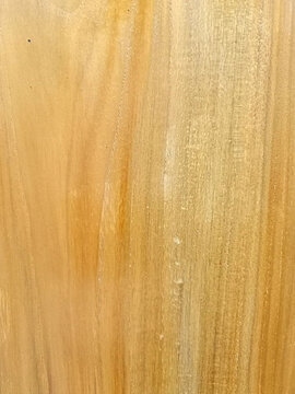 Light oak wood texture with vertical grain and pale honey tones serves as a minimalist organic background for modern interior design and sustainable architecture.