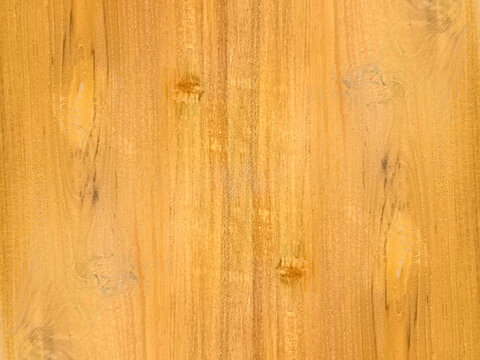 Light yellow brown wood grain texture background showing symmetric timber patterns with soft natural highlights perfect for clean furniture design and paneling.