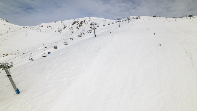 Aerial view of Cerro Catedral ski resort with chairlifts and skiers on the snow-covered slopes in Bariloche Department, Rio Negro Province, Argentina.