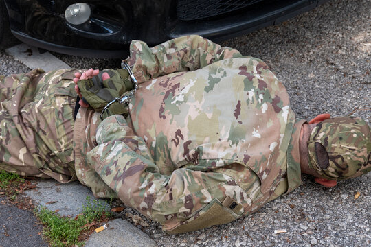 Conceptual scene of military police and counterintelligence services detaining a person suspected of espionage.