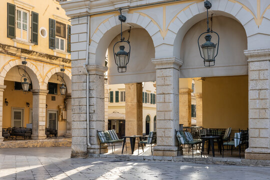 Old town corfu city in the evening with low standing sun. Pedestrian area with arcades. Corfu island, Greece