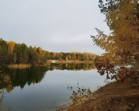 Beautiful autumn lake with colorful forest reflection in the calm water mirror