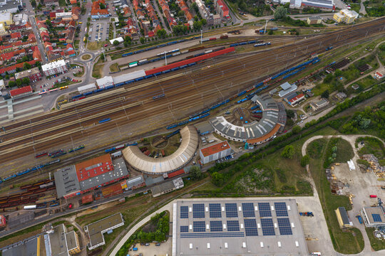 Aerial view of the historic railway roundhouse depot with circular buildings and train tracks in the industrial area of Breclav, South Moravian Region, Czechia.