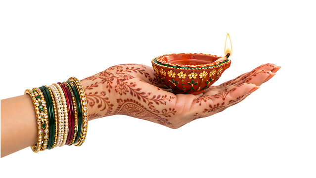 Decorated clay diya lamp resting on mehndi hand with colorful festive bangles durga puja diwali isolated on a transparent background