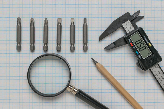 Precision Measurement Tools and Graph Paper Background for Engineering Projects