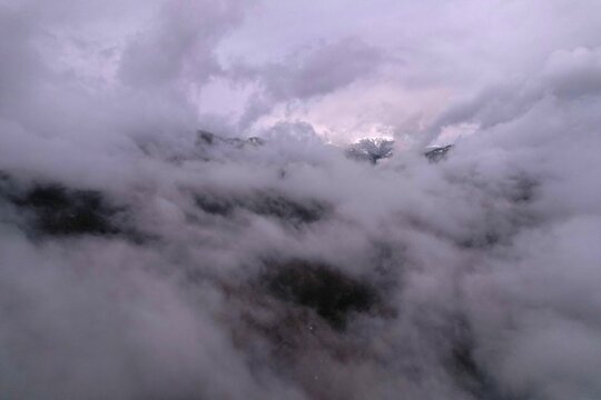 Aerial view of dense clouds covering the mountainous landscape of the Borjomi region in Borjomi, Samtskhe-Javakheti, Georgia.