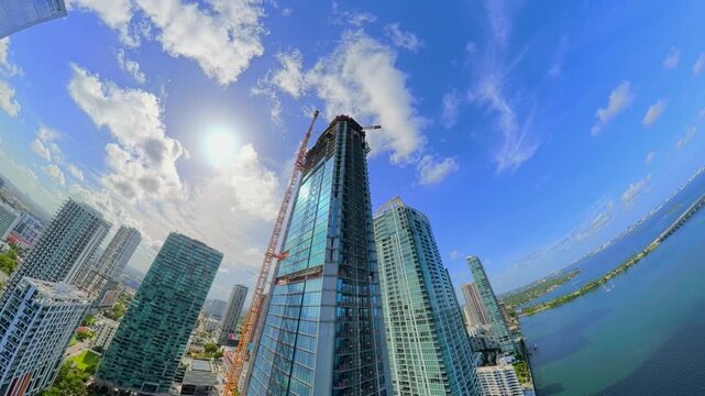 Aerial rising transition from towers to tiny planet Miami Edgewater