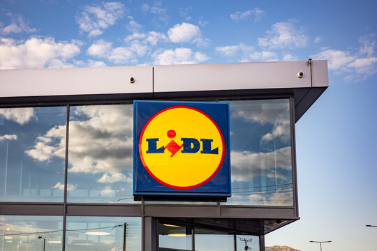 Vibrant company logo situated on the modern glass facade of a large retail store illustrating the scale of global supermarket chains.