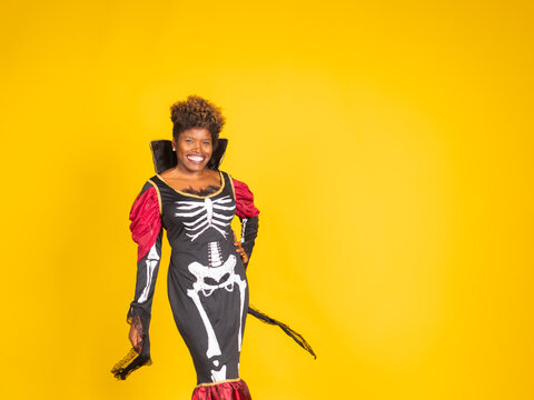 African american woman celebrating halloween wearing skeleton costume