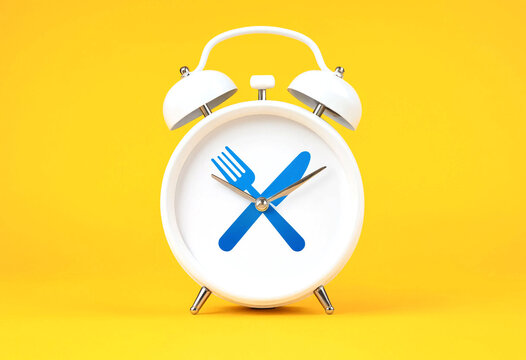 White alarm clock featuring crossed blue fork and knife graphic design