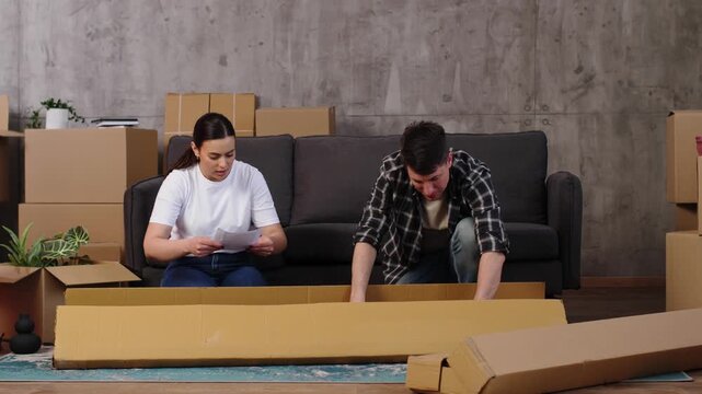 Frustrated couple assembling flat pack furniture together